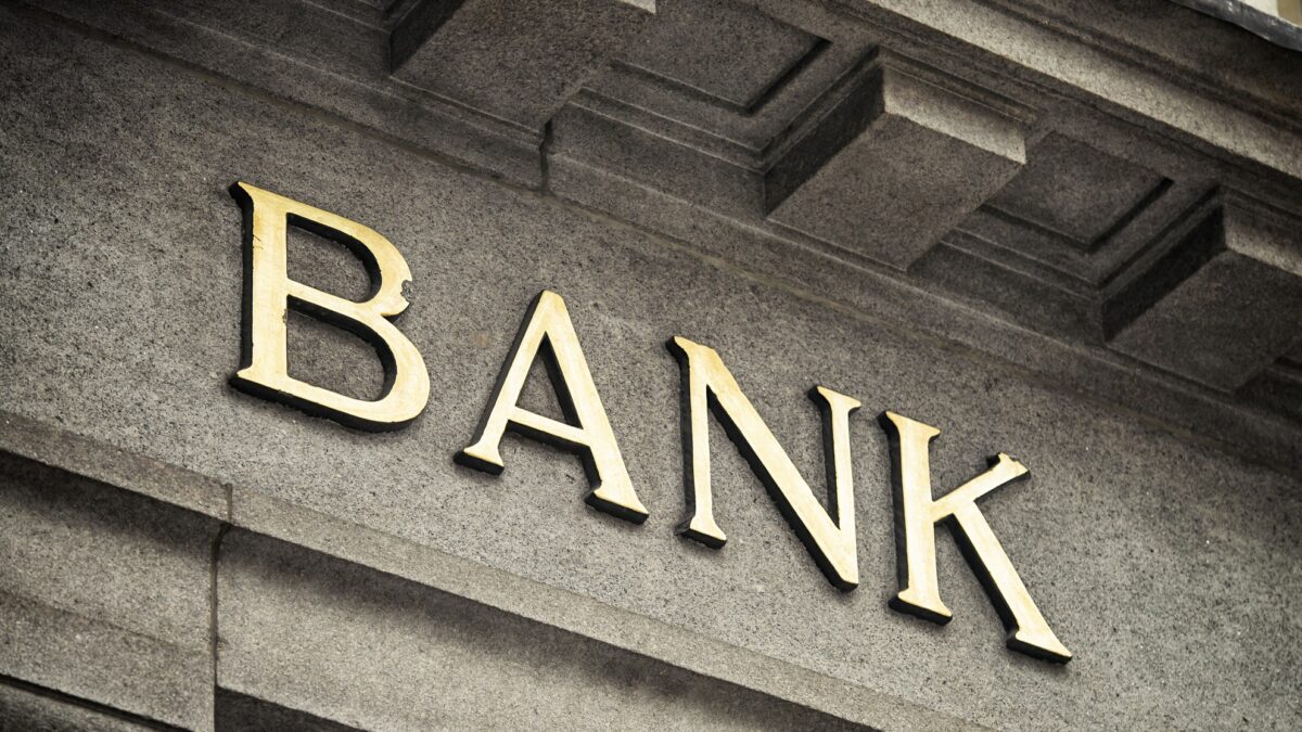 An old fashioned 'Bank' sign on a building exterior.