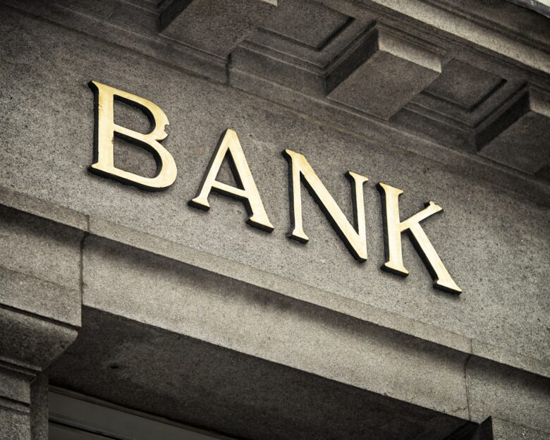 An old fashioned 'Bank' sign on a building exterior.