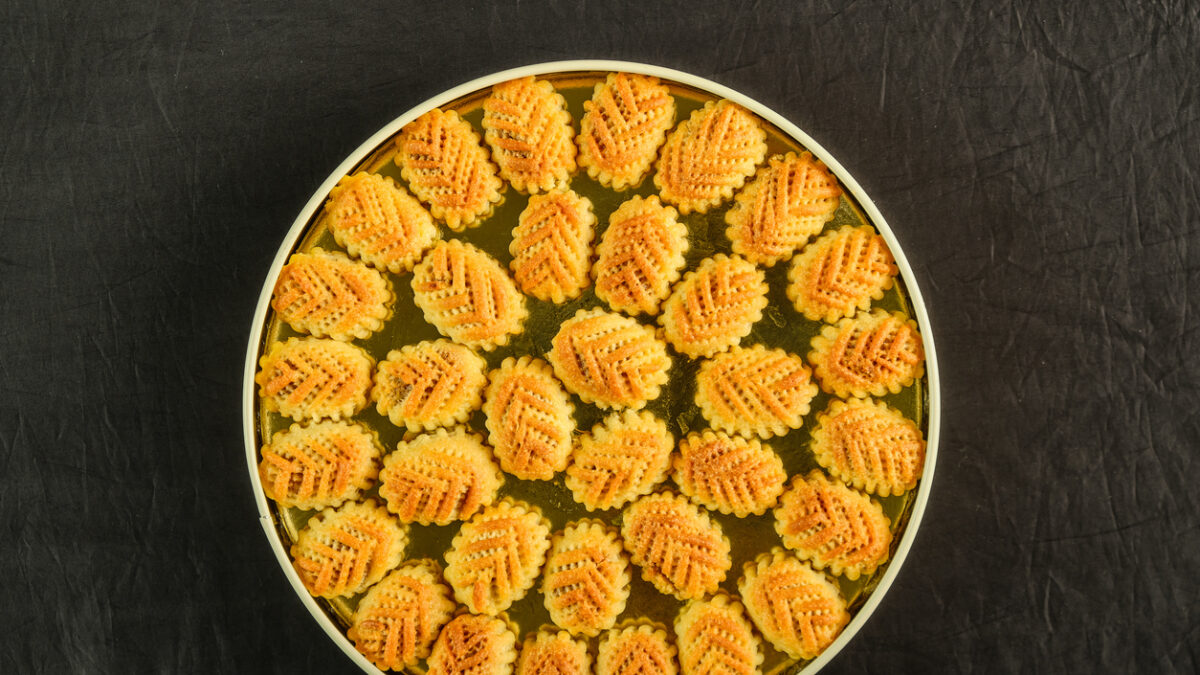 Arabic sweets boxes. Pictured from above showing several shapes and types of sweets with sesame, pistachios, dates and walnuts.