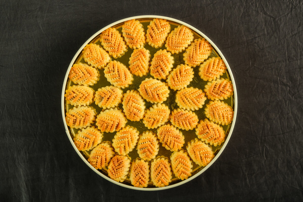 Arabic sweets boxes. Pictured from above showing several shapes and types of sweets with sesame, pistachios, dates and walnuts.