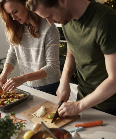 Caucasian couple cooking together before Christmas
