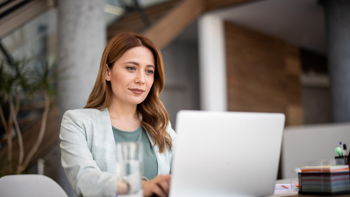 Successful businesswoman using laptop, working in office. Business technology corporate concept
