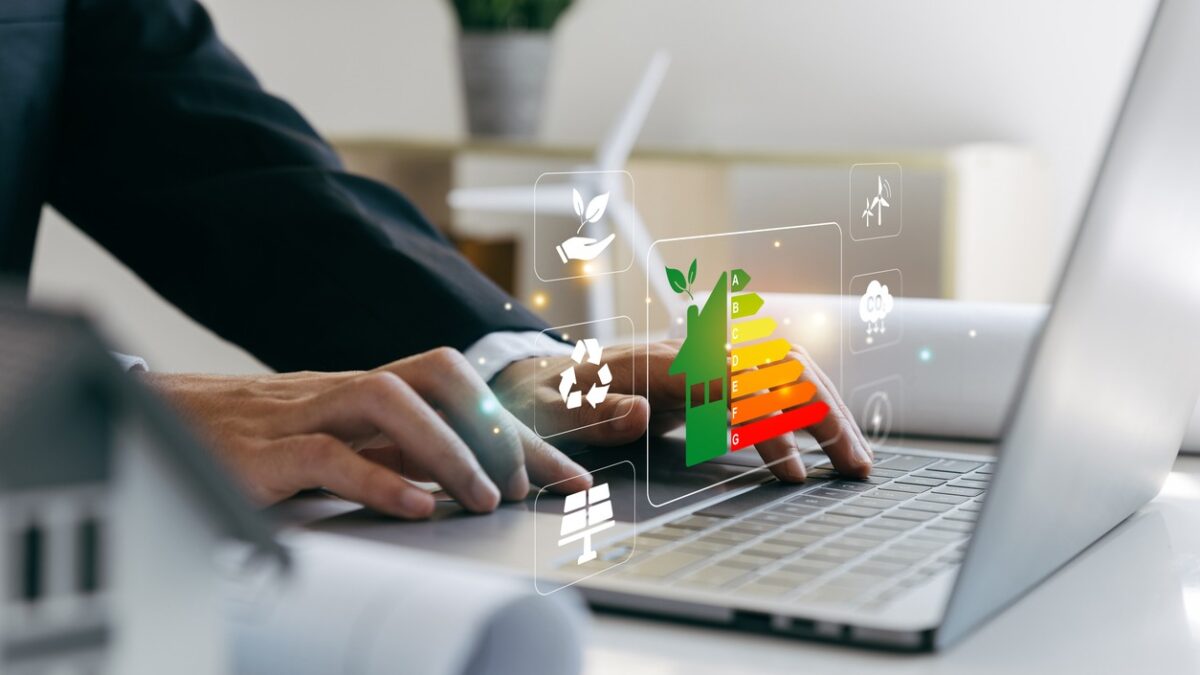 Hand of businessman using laptop with energy efficiency rating