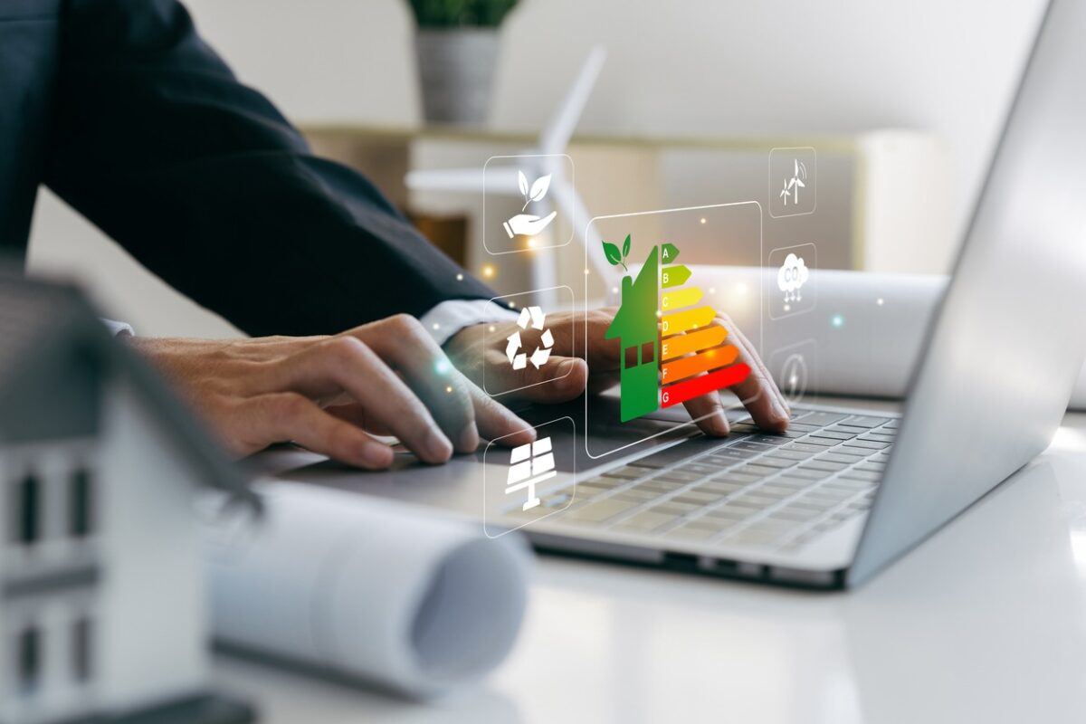 Hand of businessman using laptop with energy efficiency rating