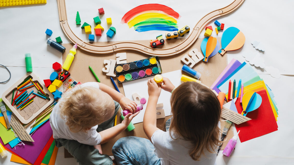 Children drawing and making crafts in kindergarten or daycare. Little kids with educational toys and supplies for creative. hildren education and development in preschool or childcare.