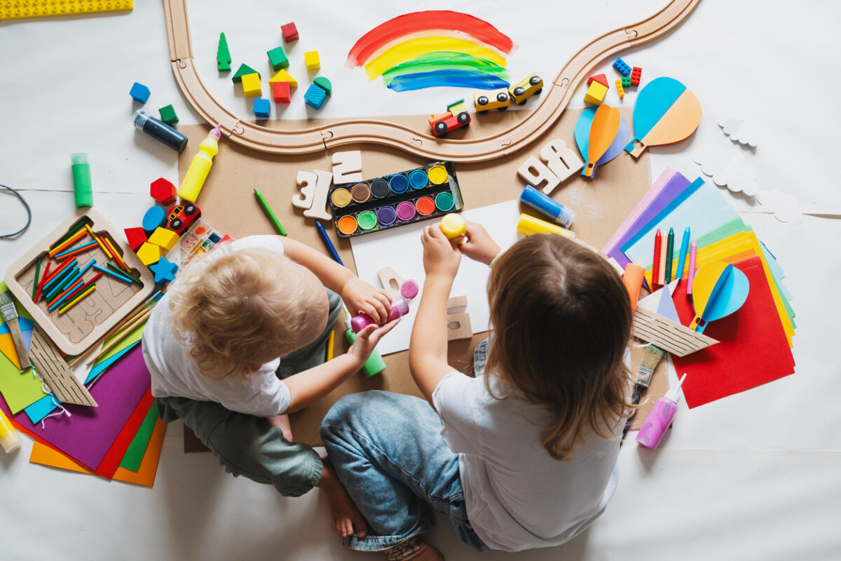 Children drawing and making crafts in kindergarten or daycare. Little kids with educational toys and supplies for creative. hildren education and development in preschool or childcare.