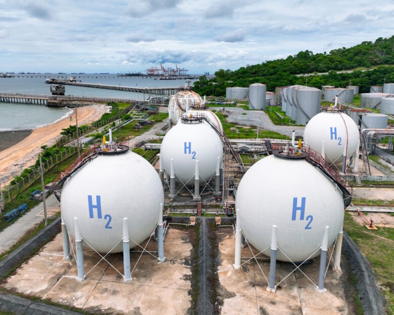 Green hydrogen storage facility with industrial H2 gas tanks in sustainable energy plant. Zero emission technology for clean energy production. Sustainable energy infrastructure and clean power.