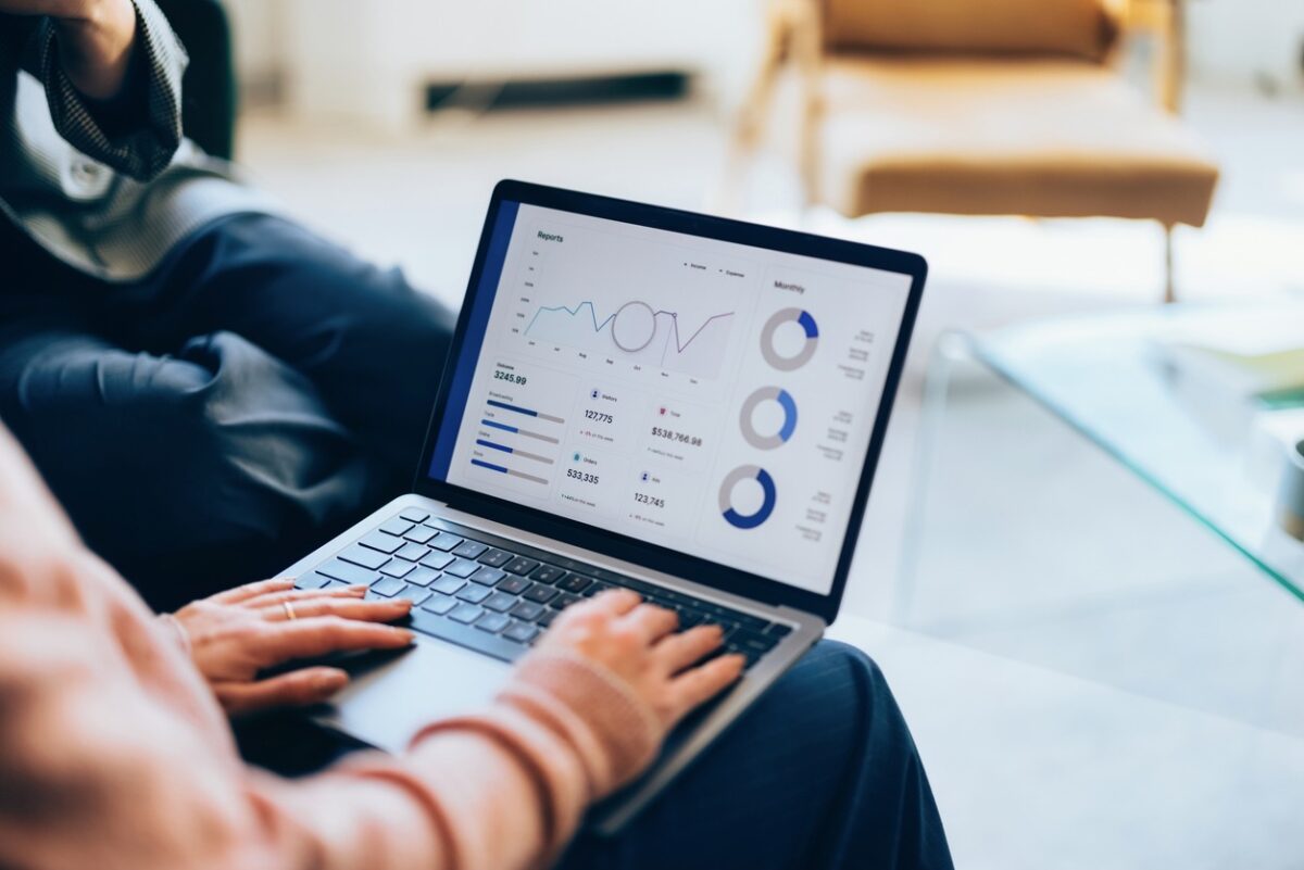 Focused on a laptop, showcasing detailed analytics and reports