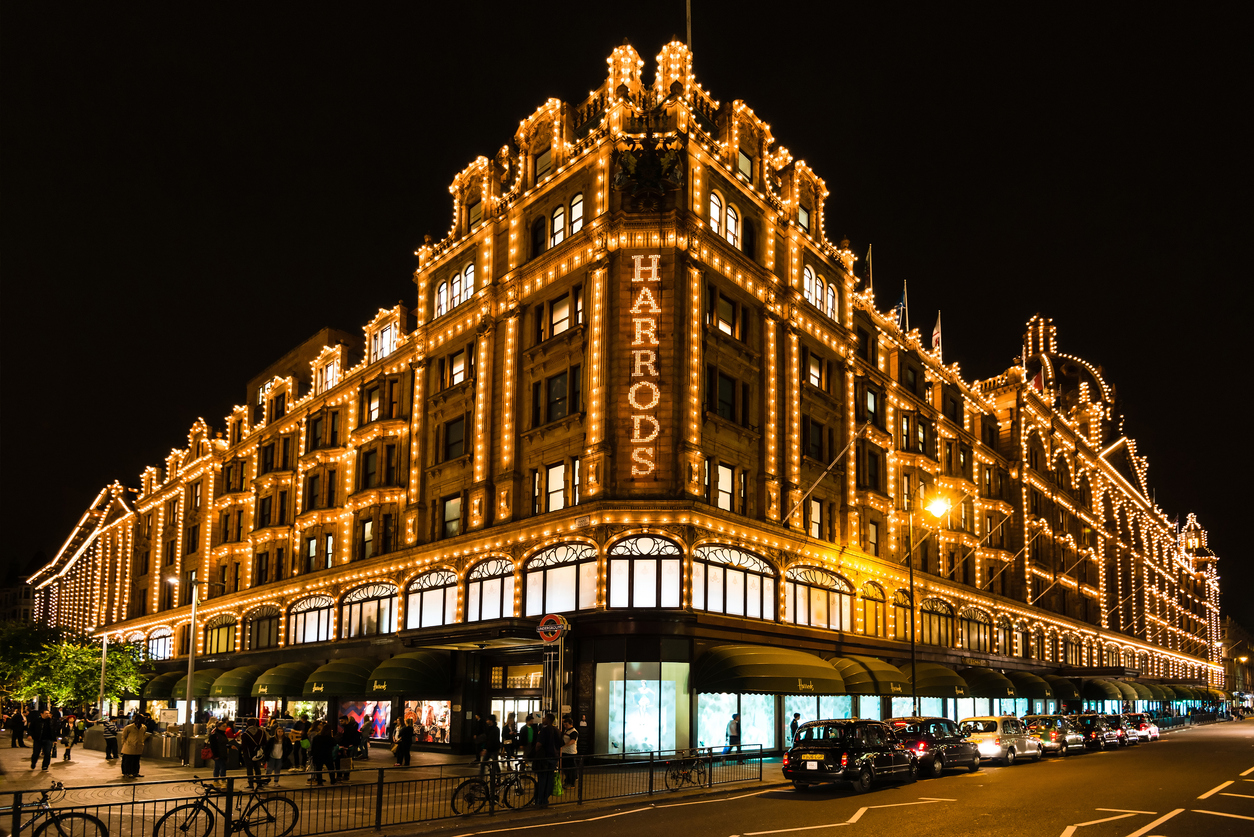 London, United Kingdom - September 25, 2014: The famous Harrods department store in the evening of September 25, 2014 at Knightsbridge in London, UK. Harrods is the biggest department store in Europe and offers over one million square feet of retail space, acting as a magnet for rich clients and numerous tourists throughout the year.