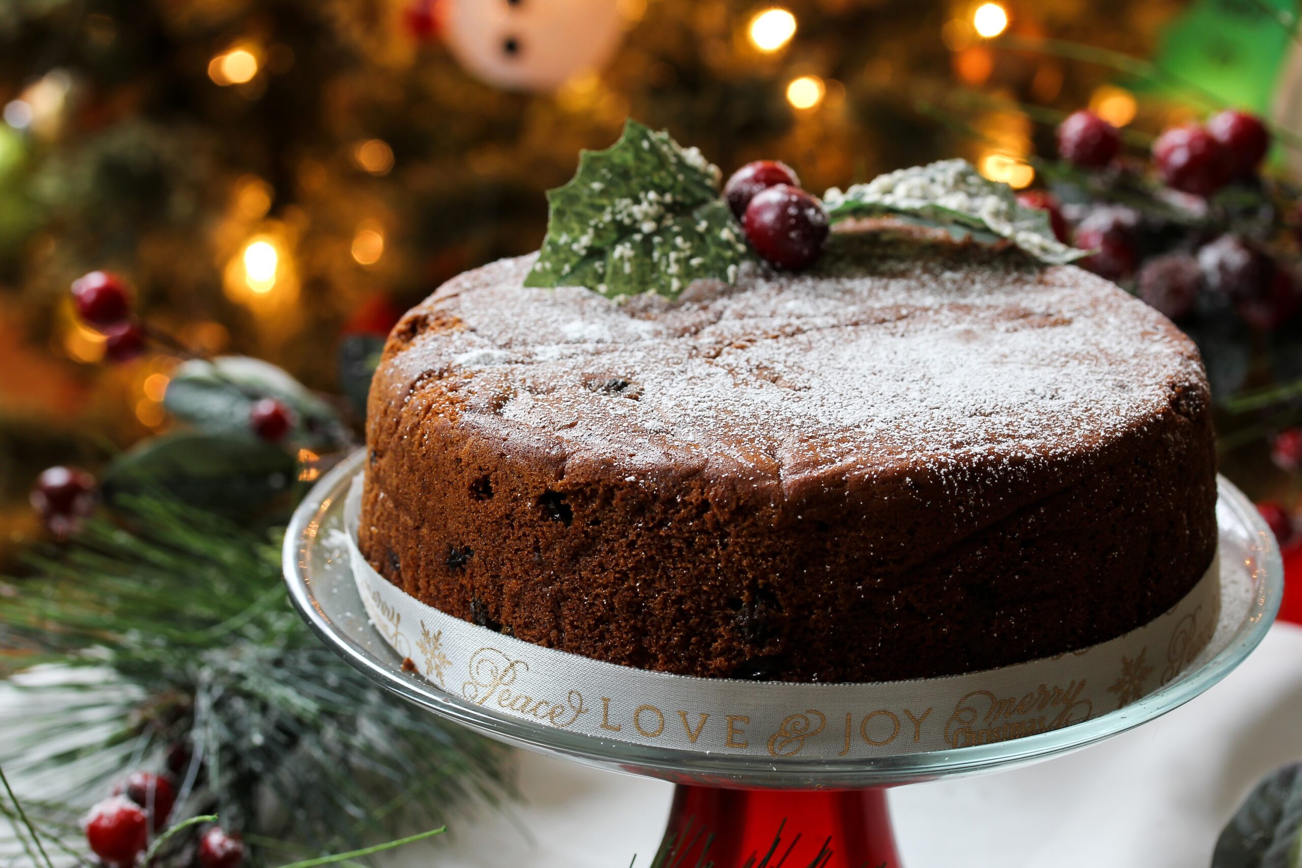 Homemade Christmas fruit cake on Holiday bokeh background, selective focus