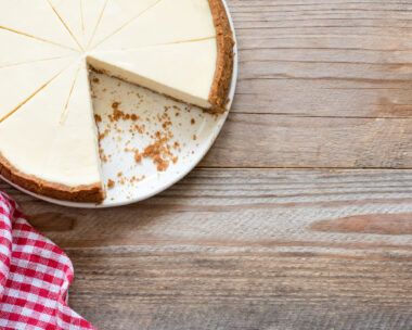 New York cheesecake on wooden background or food background with cheesecake. Top view and copy space for text