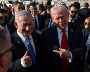 FILE PHOTO: U.S. President Donald Trump  gestures next to Israeli Prime Minister Benjamin Netanyahu at Ben Gurion International Airport in Lod, Israel, October 13, 2025. REUTERS