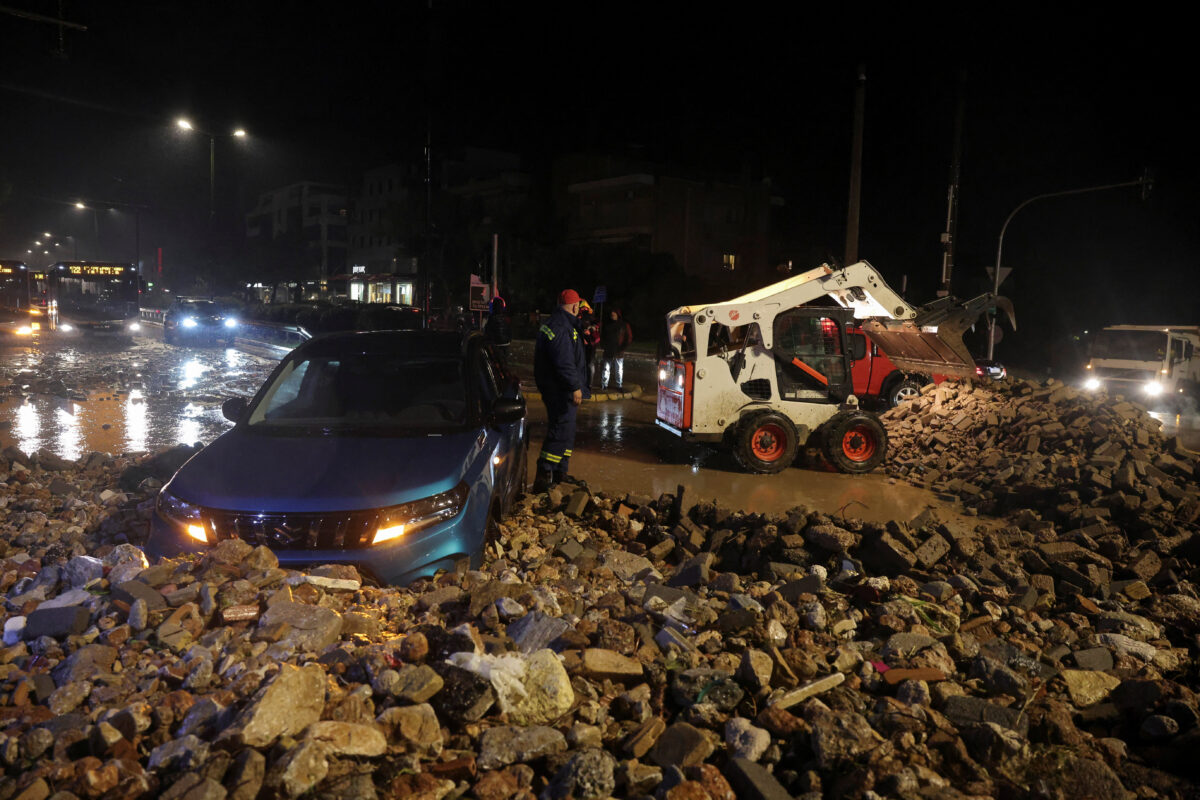 A car is partially covered by debris, as a storm hits Athens, Greece, January 21, 2026. REUTERS