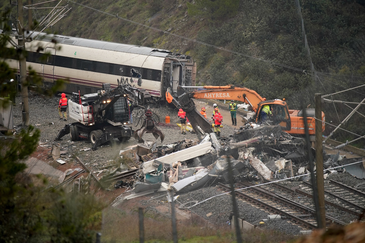 Οι εργάτες χειρίζονται βαριά μηχανήματα καθώς συνεχίζονται οι εργασίες απομάκρυνσης μετά από μια θανατηφόρα εκτροχία δύο τρένων υψηλής ταχύτητας κοντά στο Adamuz