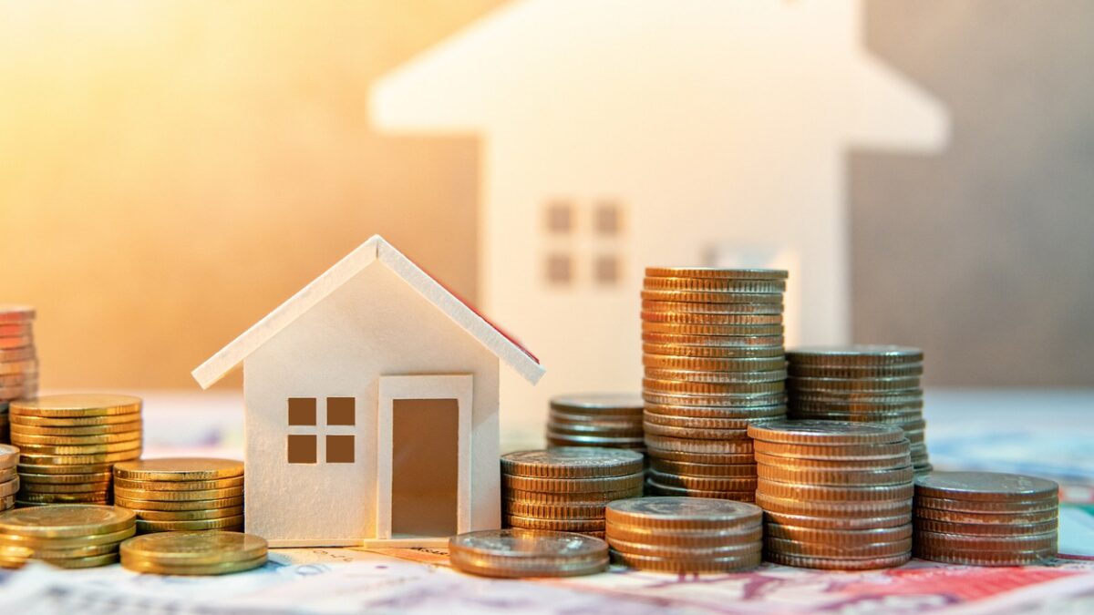 Real estate or property investment. Home mortgage loan rate. Saving money for retirement concept. Coin stack on international banknotes with house model on table. Business growth background