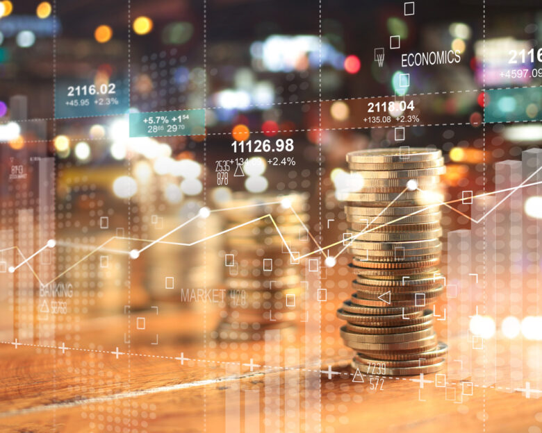 Double explosure with businesss charts of graph and rows of coins for finance at night city background