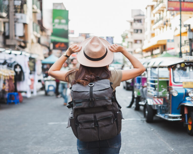 Back view Asian woman tourist backpacker travel in Khao San road, Bangkok, Thailand