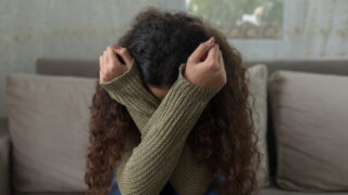 Unhappy girl on sofa