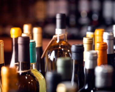 Bottles of wine on the shelves of an alcohol shop in Spain, Alicante. Background, horizontal orientation