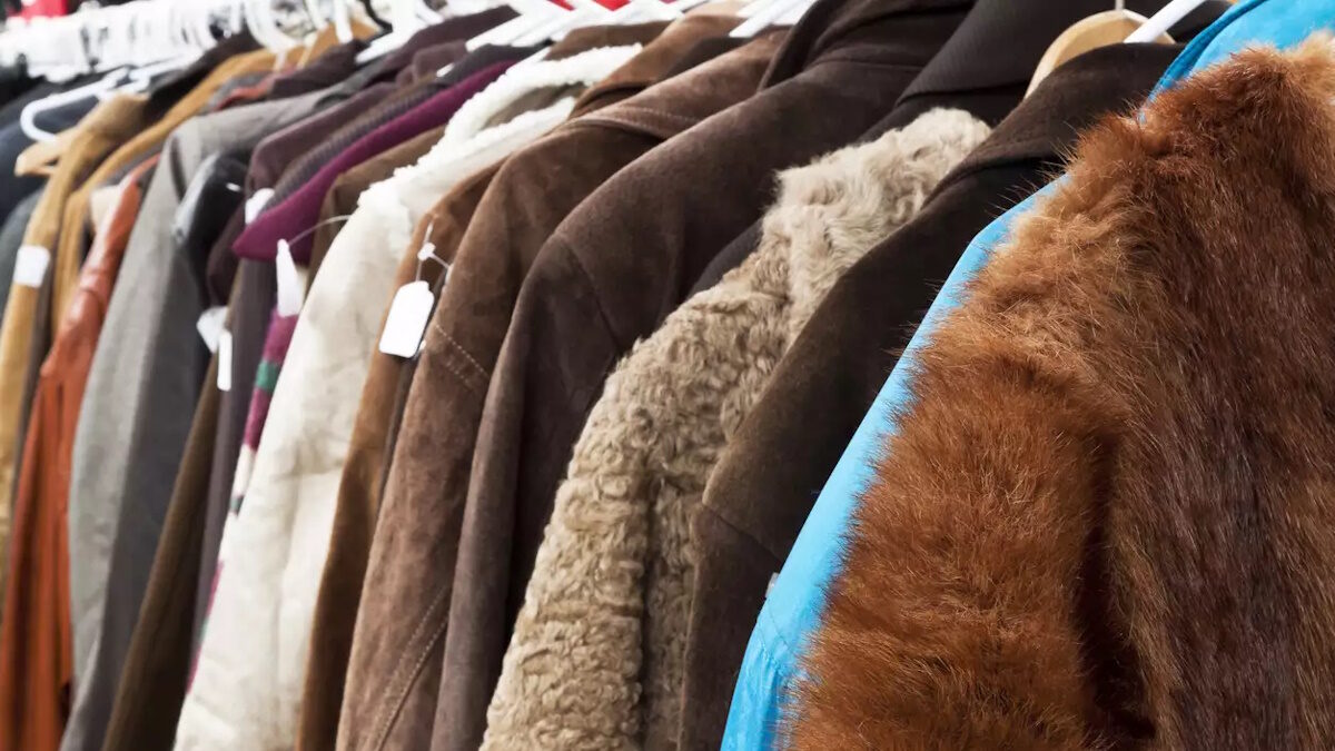 Close up secondhand winter coatsand jackets hanging the shop, full frame horizontal composition