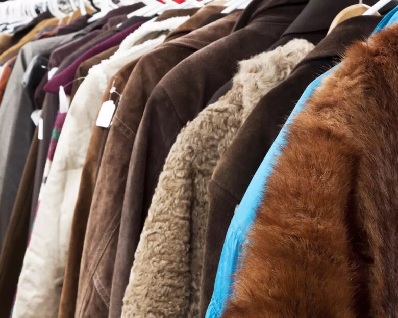 Close up secondhand winter coatsand jackets hanging the shop, full frame horizontal composition