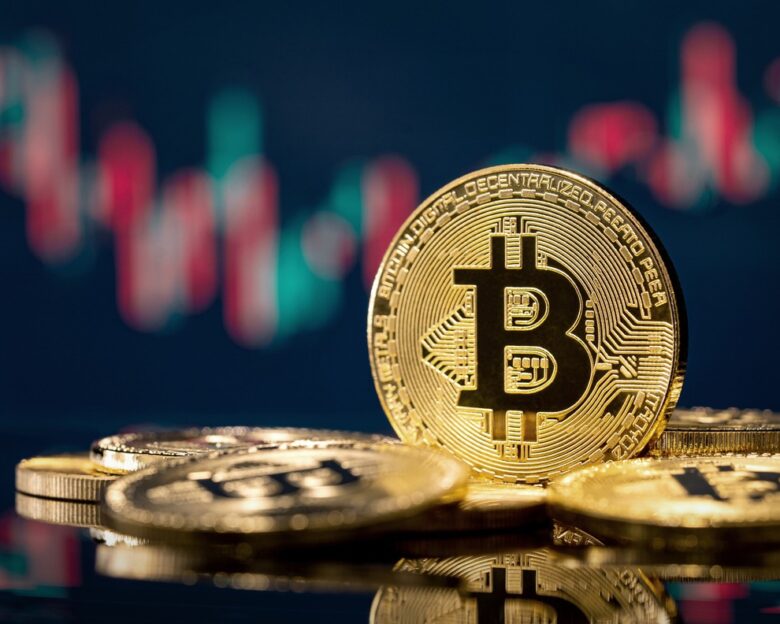 Golden bitcoin coin over defocused stock chart with copy space, Olsztyn, Poland 13 July 2021