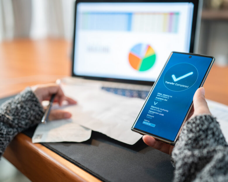 Woman Using banking app on the smartphone pay utility bill, personal finance at home, financial Technology in real life , New normal lifestyle concept