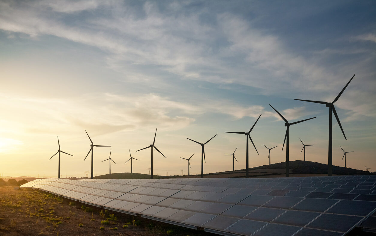 Solar panels and wind turbines generating renewable energy for green and sustainable future.