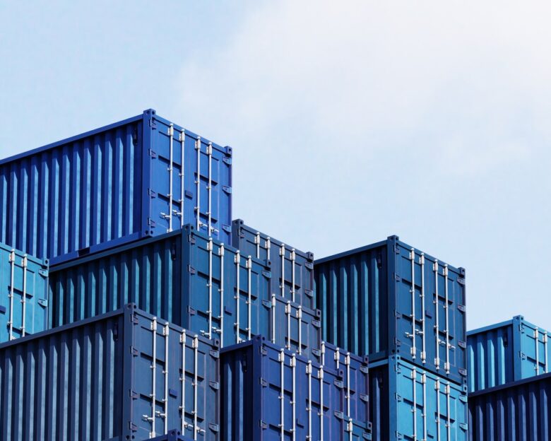 Stack of blue container boxes with sky background. Cargo freight shipping for import and export logistics. Business and transportation concept. 3D illustration rendering