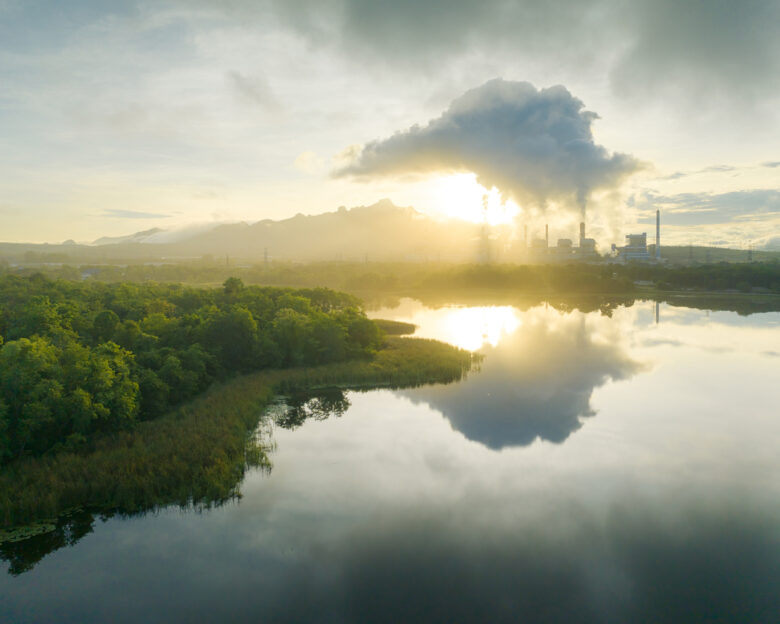 Aerial view coal power plant station in the morning mist, the morning sunrises. coal power plant and environment concept. Coal and steam. Mae Moh, Lampang, Thailand.