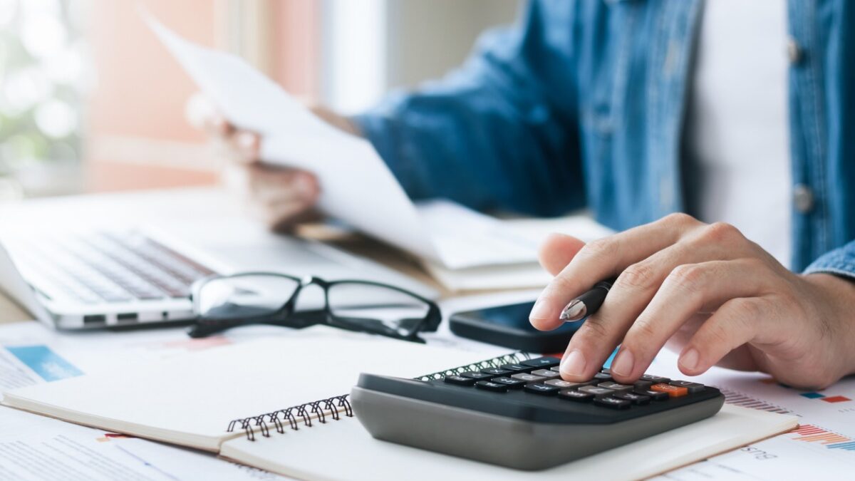 Investors are calculating profits and costs with calculators, growth and investment chart analysis, business planning and strategies to maximize sales profits. Long term business plan