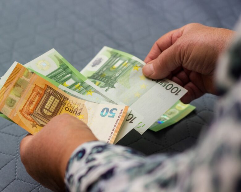 Senior woman hands counting money at home