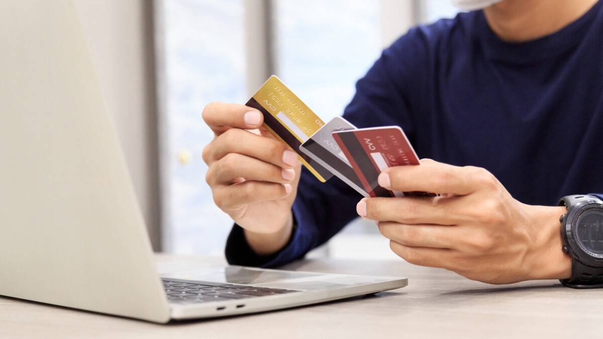 Businessman holding credit card for online shopping bill on smartphone, positive man shopping online remote payment , smart payment concept individual bank