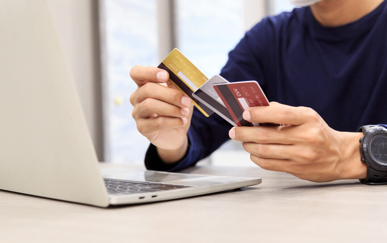 Businessman holding credit card for online shopping bill on smartphone, positive man shopping online remote payment , smart payment concept individual bank