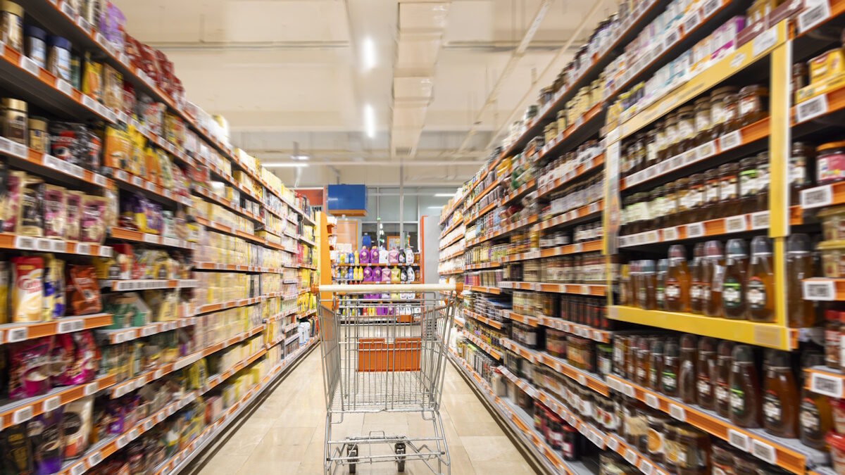 Empty cart in supermarket aisle