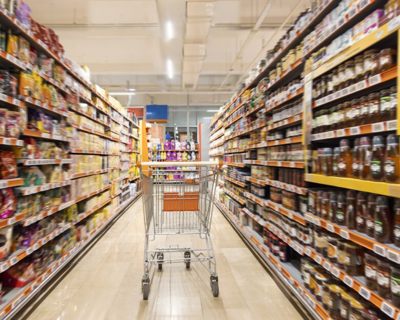 Empty cart in supermarket aisle