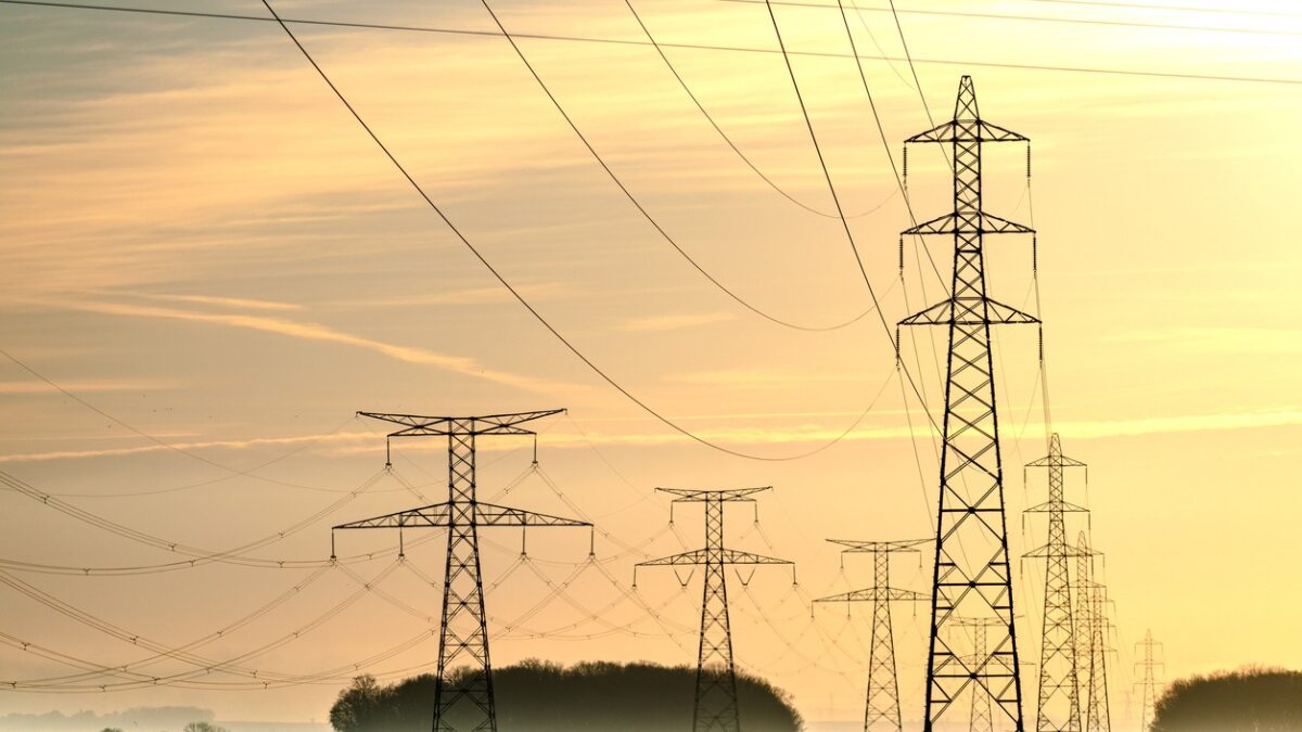Sunrise with an electricity pylon and nature