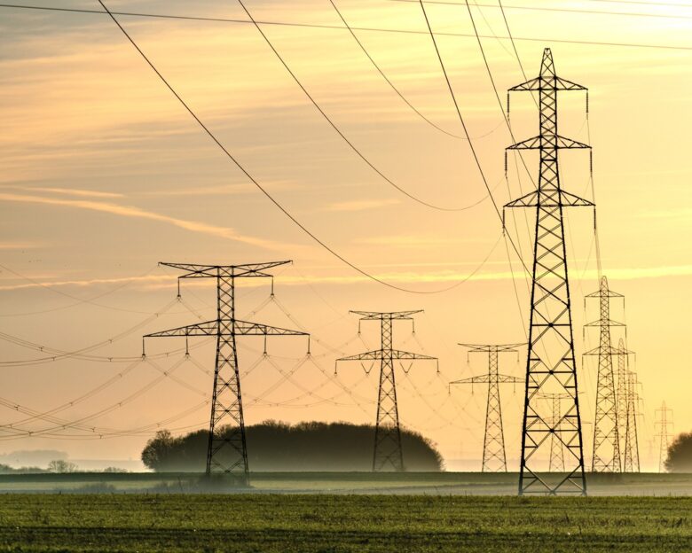 Sunrise with an electricity pylon and nature