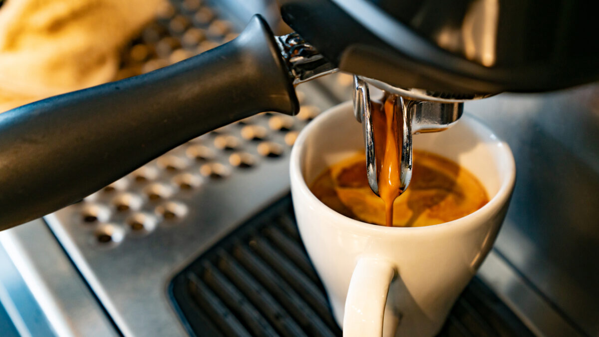Close-up on a coffee maker making a espresso at a cafe - food and drink concepts