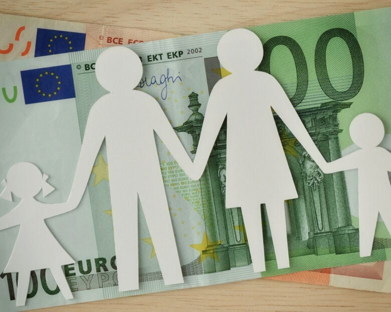 Paper family cut-out on euro banknotes - Family budget concept