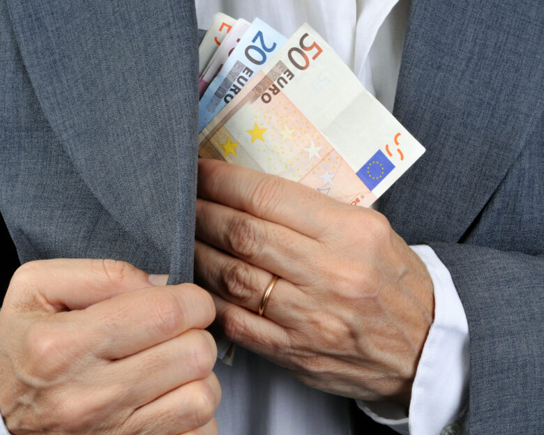 man putting money in his pocket