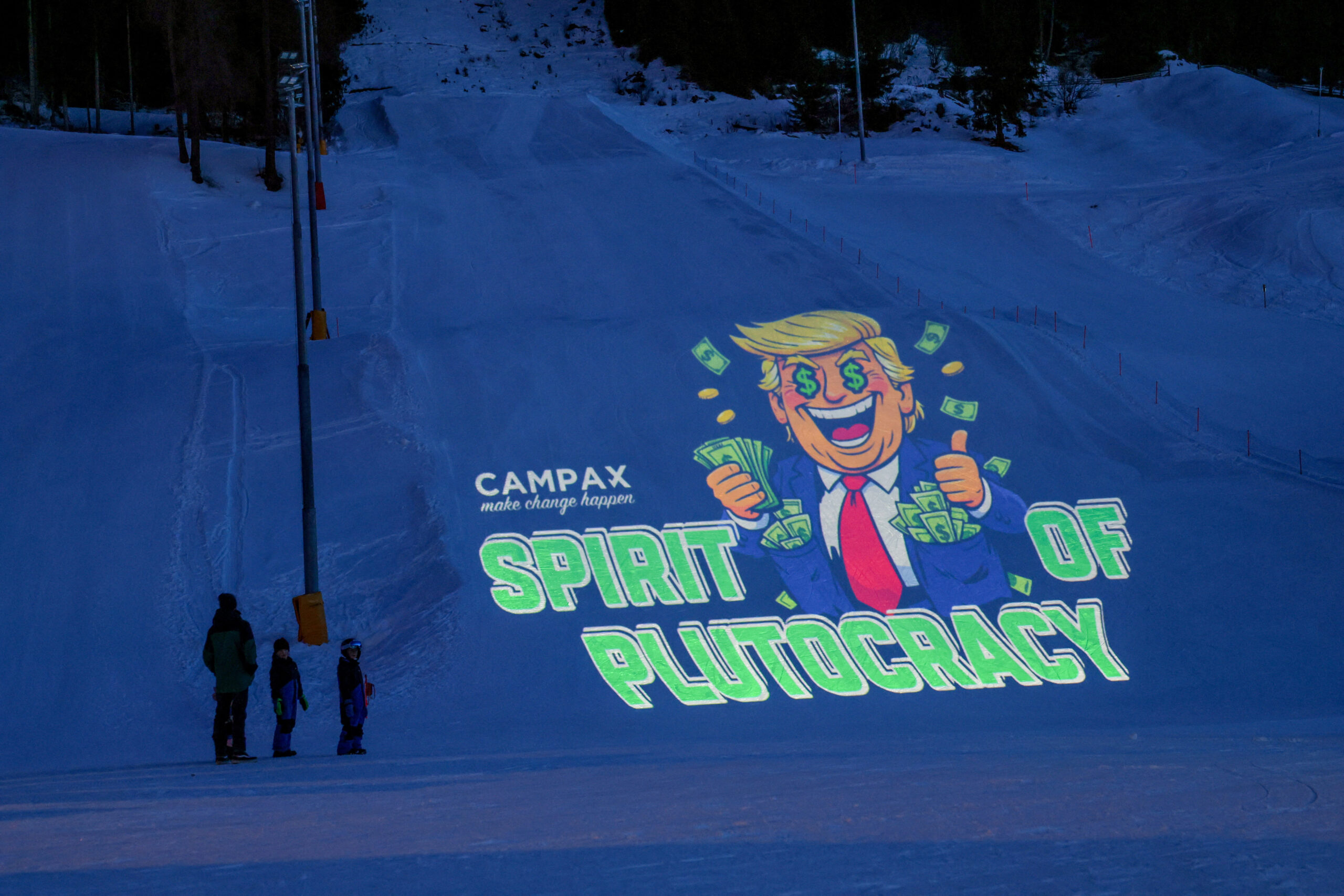 Activists from the Swiss NGO Campax project a cartoon image of U.S. President Donald Trump onto a ski slope during a protest against his attendance at the World Economic Forum (WEF) annual meeting in Davos, Switzerland, January 19, 2026.