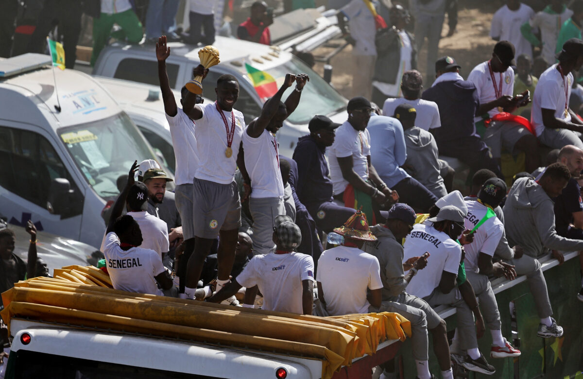 Soccer Football - CAF Africa Cup of Nations - Morocco 2025 - Final - Senegal Victory Parade - Dakar, Senegal - January 20, 2026 Senegal players and staff celebrate with the trophy on the bus during the victory parade REUTERS