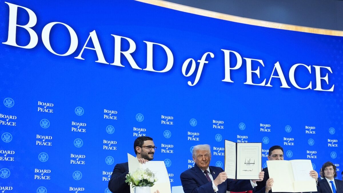 President Donald Trump, center, holds up a signed Board of Peace charter during the Annual Meeting of the World Economic Forum in Davos, Switzerland, Thursday, Jan. 22, 2026.