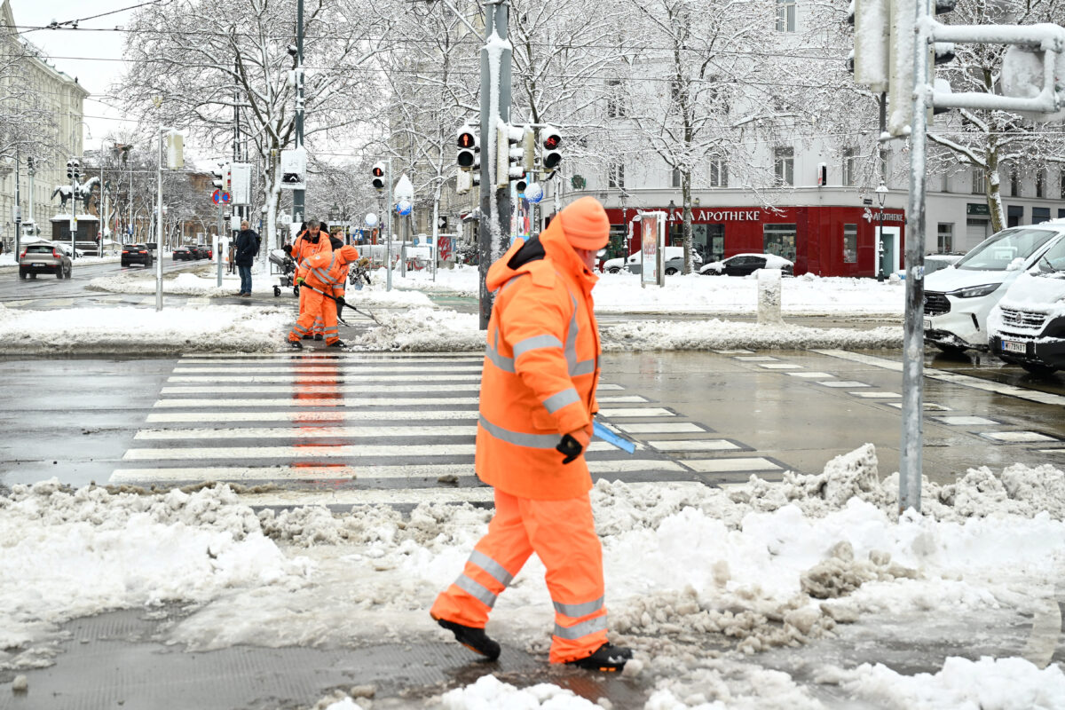 Workers clear snow from the streets after heavy snowfalls hit the country, in Vienna, Austria, February 20, 2026. REUTERS/Elisabeth Mandl