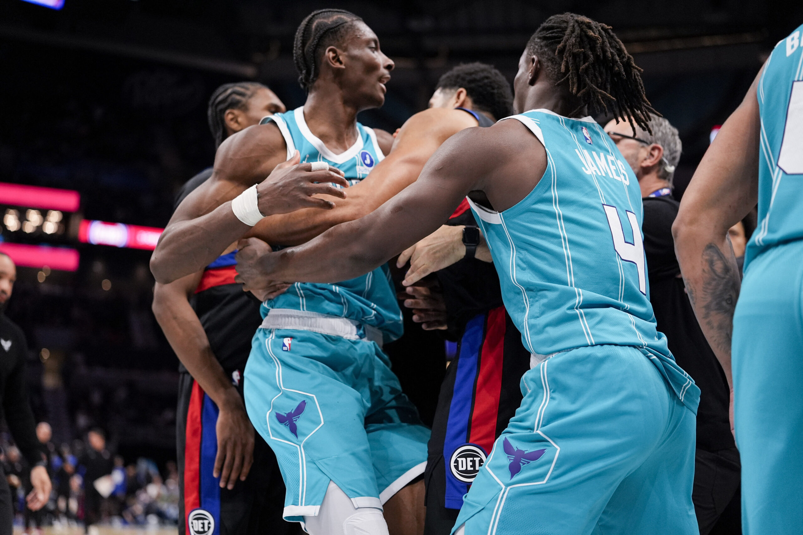 Feb 9, 2026; Charlotte, North Carolina, USA; Charlotte Hornets forward Moussa Diabaté (14) is held back by guard Sion James (4) engaging with Detroit Pistons forward Tobias Harris (12) during the second half at Spectrum Center. Mandatory Credit: Jim Dedmon-Imagn Images