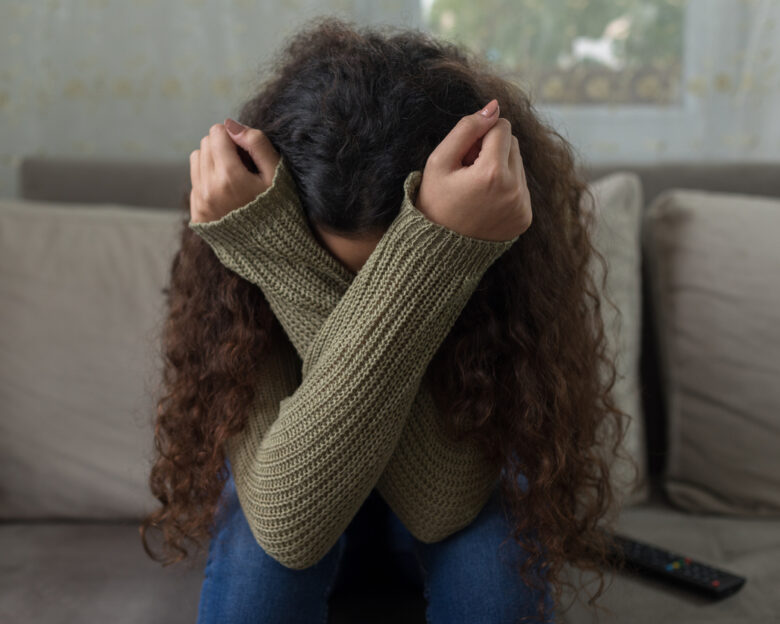 Unhappy girl on sofa