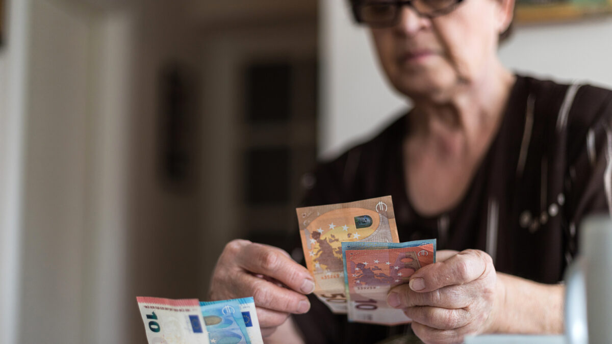 Old woman holding money in her hands