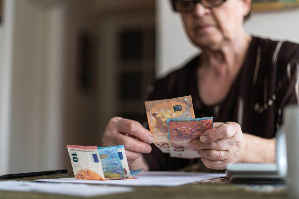 Old woman holding money in her hands