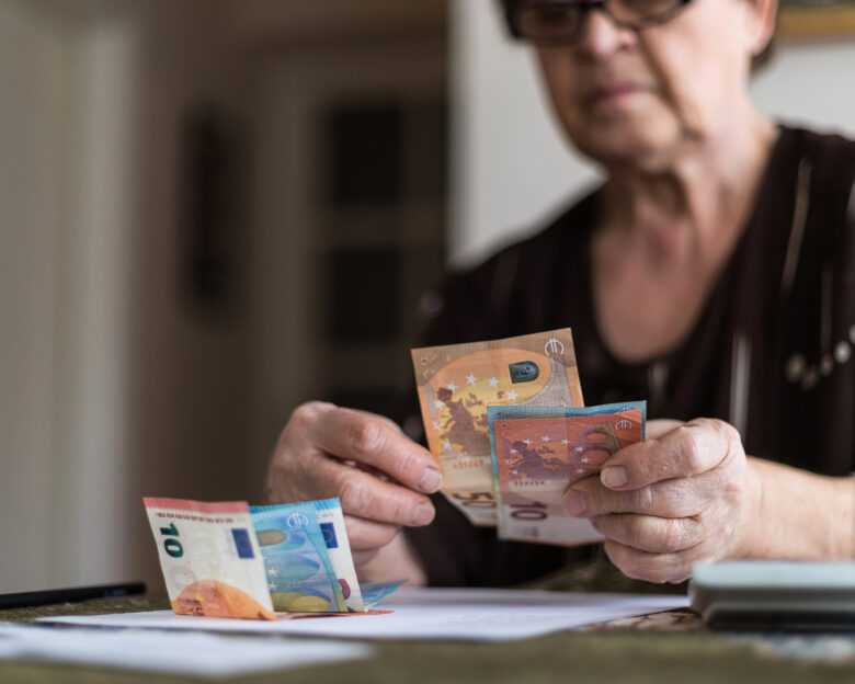 Old woman holding money in her hands